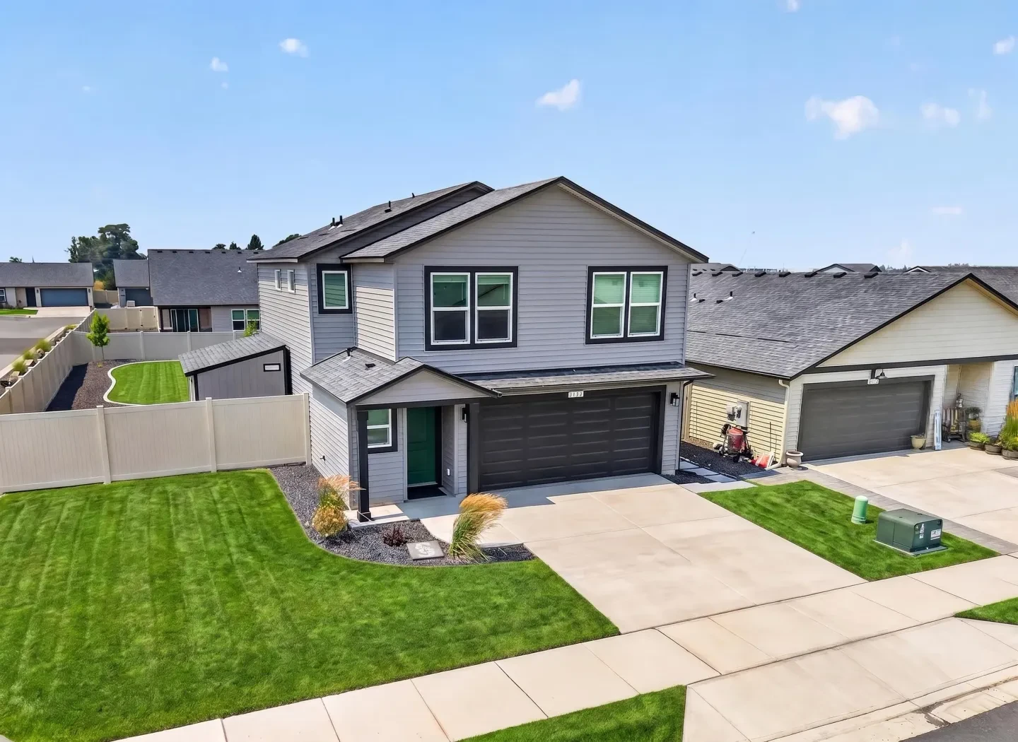 Aerial front view of modern home with green garage door