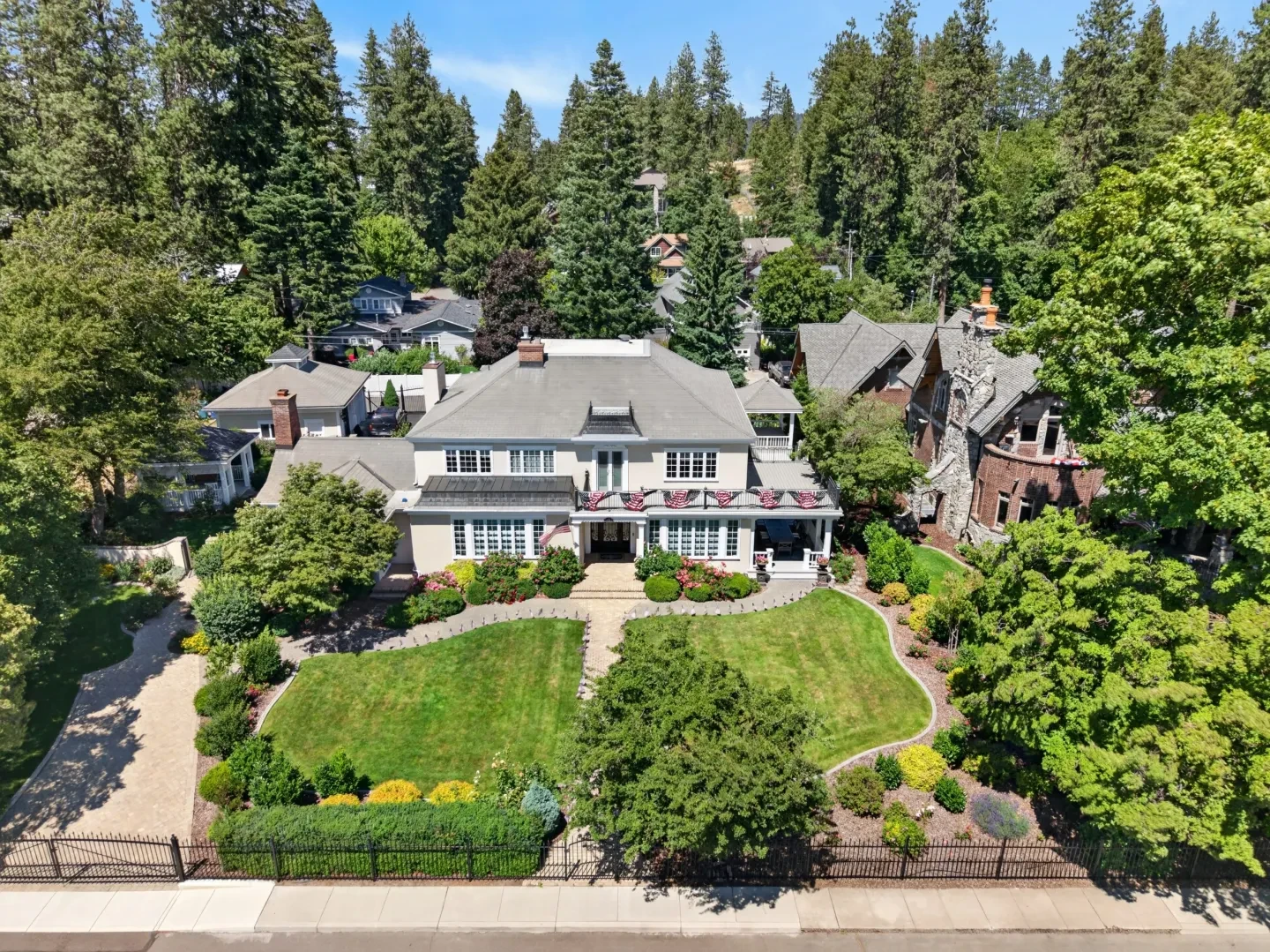 Aerial view of luxury estate surrounded by mature trees