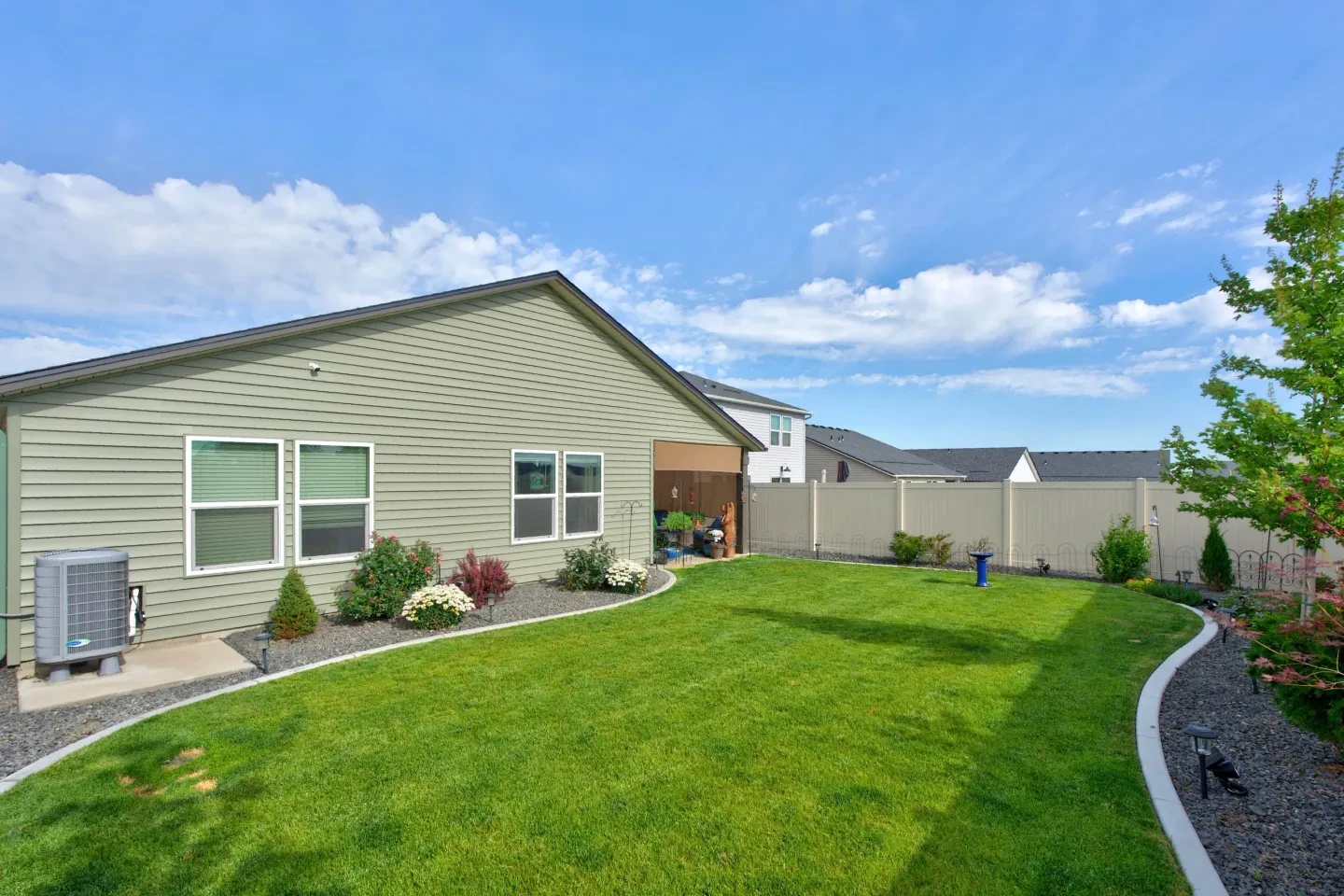 Rear exterior with patio and garden beds